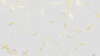 Golden flickering confetti party popper falling on light background