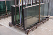 A palette with new prepared glass windows at the construction site. installation of windows