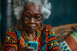 An afro-american senior woman using a mobile phone indoors.