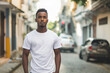 © Vectorsection - African American man wearing an empty white T-shirt standing on a street mockup