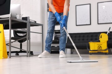 Poster - Cleaning service. Man washing floor with mop, closeup