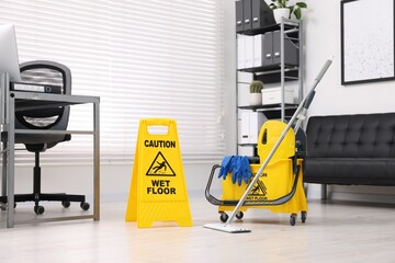 Poster - Cleaning service. Mop, wet floor sign and bucket with supplies in office