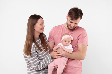 Wall Mural - Happy family. Parents with their cute baby on light background