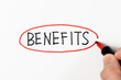 Hand writing benefits with red marker on white background