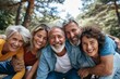 © Loli - Portrait of a group of senior friends having fun in the park.