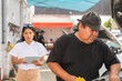 © Guillermo Spelucin - Mechanic working next to secretary holding papers