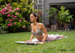 Calm beautiful slim girl doing yoga in the garden