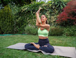 Attractive fir woman doing yoga exercises, stretching arms, eagle arms 