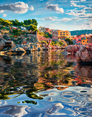 Wall Mural - old colorful building of sant' elia village reflected in the calm waters of mediterranean sea. pictu
