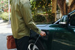 © DragonImages - Cropped image of electric car owner inserting charging plug