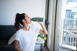 © amanaimages - 室内で水分補給をしている女性