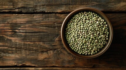 Poster - Bowl of raw green buckwheat grains on wooden surface from above with room for text