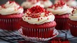 Vibrant red velvet cupcakes with creamy cheese frosting, close-up, decorated with red velvet crumbs, on a silver stand. 