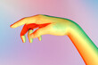 Illuminated hand with vivid colors on blurred background