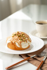 Wall Mural - Cinnamon roll bun with icing on plate