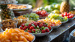 A continental breakfast spread, with colorful fruits as the background, during a sunny morning
