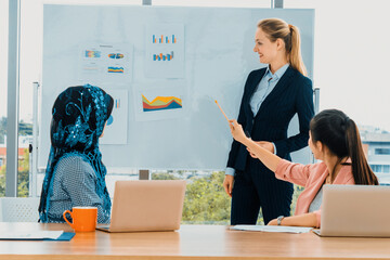 Wall Mural - Multicultural work group. Team of businesswomen of different ethnicity, Caucasian, Asian and Arabic working together in team meeting with laptop computer at office. Multiethnic teamwork concept. uds