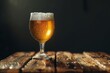 Glass of beer on a wooden table on a dark background, close-up