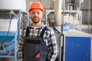 Wall Mural - Portrait of factory worker. Young handsome factory worker