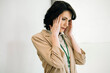 © Westend61 - Mature businesswoman touching temples suffering from headache at office