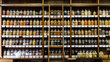 © Westend61 - Variety of condiments jars arranged on shelves in departmental store
