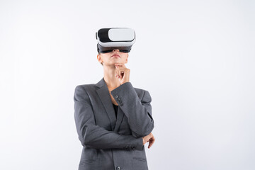 Businesswoman thinking about marketing plan while wearing VR glasses at white background. Manager checking at financial graph while using visual reality goggles. Innovation technology. Contraption.