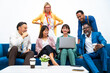 © Westend61 - Businesswoman using laptop sitting with multi-ethnic colleagues on sofa at office
