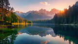Fototapeta Natura - Calm morning view of Fusine lake. Colorful summer sunrise in Julian Alps with Mangart peak on background, Province of Udine, Italy, Europe. Beauty of nature concept background.