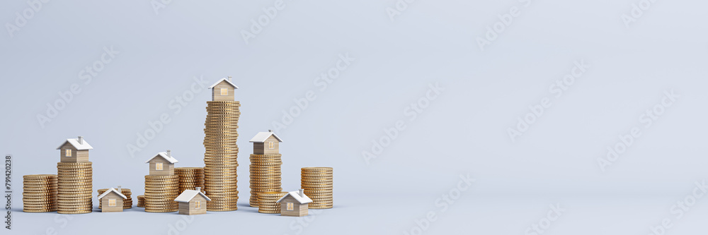 Stacked golden coins with small houses on wide light background with ...