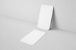 © Regi Munandar - blank clean 90x50mm us size vertical brand identity business name card with round corner leaning to wall realistic mockup design template 3d render illustration