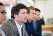© peopleimages.com - Man, audience and manager for workplace listening with planning, cooperation and business meeting. Serious male person, teamwork and attention in boardroom for discussion, partnership and workshop