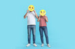 © New Africa - People covering faces with emoticons on light blue background