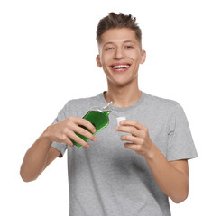 Canvas Print - Young man with mouthwash on white background