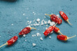 Dry chili pepper with salt as a symbol of additional species that can harm your health. Unhealthy addition to the food.