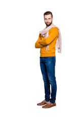 Poster - Full size fullbody portrait of stylish half turned stylist in sweater, jeans having scarf around neck and crossed arms looking at camera isolated on grey background