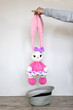 Holding a soft bunny toy. Bunny. Long ears. Hobby crochet. Handmade. Amigurumi. Pink knitted rabbit. Soft toy.  Crocheting of soft toys