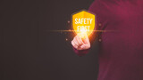 Fototapeta Na sufit - Person touching the safety banner symbol, highlighting a commitment to workplace safety, zero accidents, and fostering a culture of hazard awareness among workers.