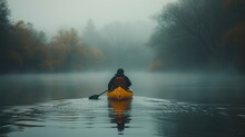 A Lone Kayaker Paddles Through A Misty Lake Surrounded By Dense Fog And Dark Trees.