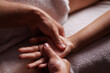 Close-up hands of professional masseuse working, massaging woman's hand in spa salon, therapeutic massage for relaxation. Healing, beauty, health, lifestyle, peace, relief, professional skills.