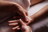 Fototapeta Łazienka - Close-up hands of professional masseuse working, massaging woman's hand in spa salon, therapeutic massage for relaxation. Healing, beauty, health, lifestyle, peace, relief, professional skills.