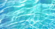 Beautiful turquoise blue ocean water surface with light reflections and highlights. Texture of water close-up macro.