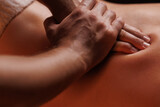 Fototapeta Łazienka - Extreme closeup of masseurs male hands gently pressing hands along clients back. Concept of aesthetic relaxing massage in spa salon, recovery, reboot.