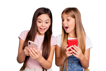 Canvas Print - Close up photo two people little she her blond brunette girls having fun long pretty hair telephone hands arms look what I have wearing casual jeans denim t-shirts isolated blue bright background