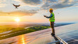 © Zape - A renewable energy technician inspecting solar panels using drone technology.