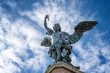 Detailed close up view of Saint Michael archangel statue with wings and sword at top of Saint Angelo castle, Rome, Italy. .