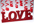 Red ribbon and word love over isolated white background