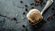 Scoop of creamy vanilla ice cream with chocolate chips on a dark background