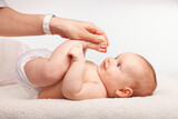Fototapeta  - Physiotherapist performing infant development exercise