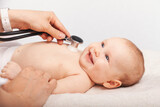 Fototapeta  - Happy Baby During Medical Check-Up