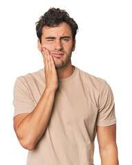 Wall Mural - Young Hispanic man in studio having a strong teeth pain, molar ache.